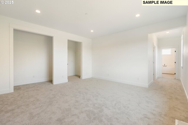 unfurnished bedroom with light carpet