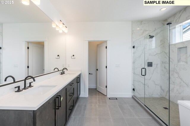 bathroom featuring vanity, tile patterned flooring, and a shower with door