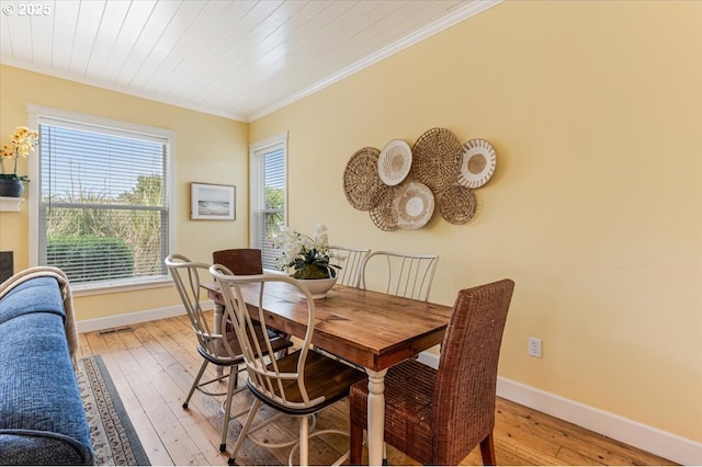 1537 NW 21st St, Lincoln City, OR 97367 - dining room featuring baseboards, light wood-style flooring, and crown molding