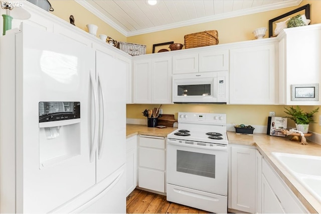 1537 NW 21st St, Lincoln City, OR 97367 - kitchen featuring white appliances, ornamental molding, light countertops, and white cabinets