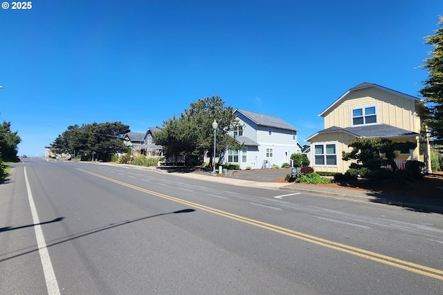 1537 NW 21st St, Lincoln City, OR 97367 - view of asphalt street featuring street lighting, curbs, and sidewalks