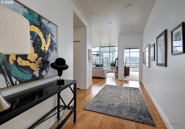 949 NW Overton St Unit 1302, Portland, OR 97209 - hallway featuring light wood-style flooring and expansive windows