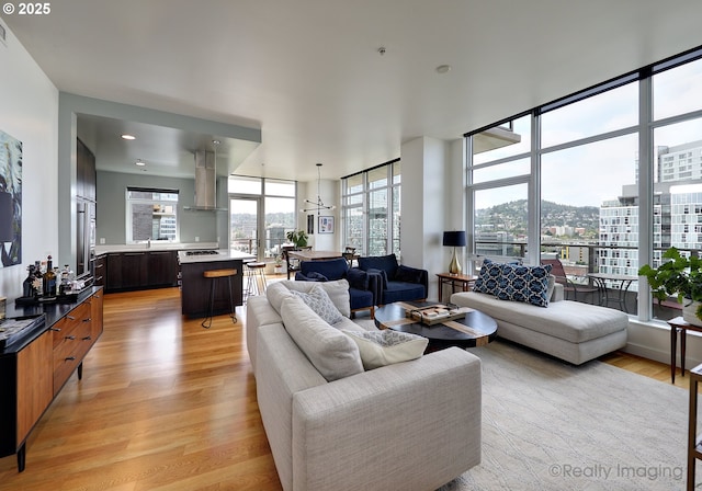 949 NW Overton St Unit 1302, Portland, OR 97209 - living area with light wood-style flooring, a city view, and expansive windows