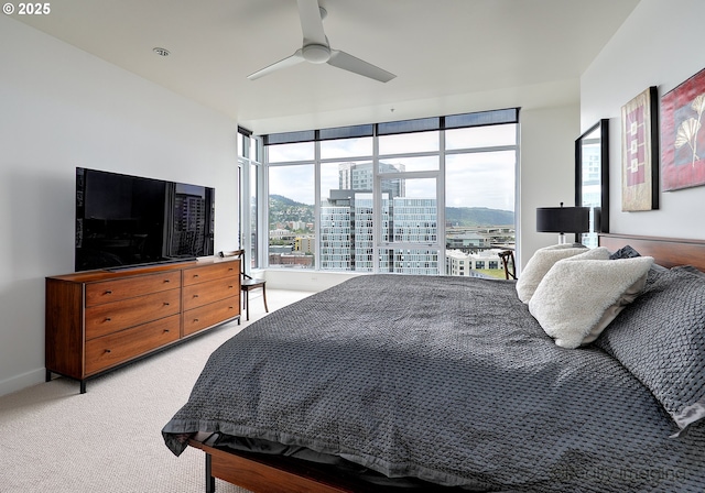 949 NW Overton St Unit 1302, Portland, OR 97209 - bedroom featuring multiple windows, light colored carpet, and a ceiling fan