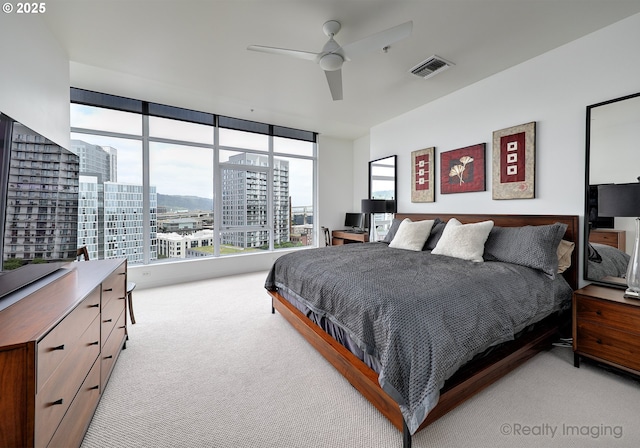 949 NW Overton St Unit 1302, Portland, OR 97209 - bedroom featuring light carpet, a view of city, and ceiling fan
