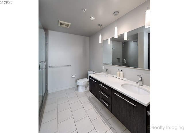 949 NW Overton St Unit 1302, Portland, OR 97209 - bathroom featuring double vanity, a shower stall, and tile patterned floors
