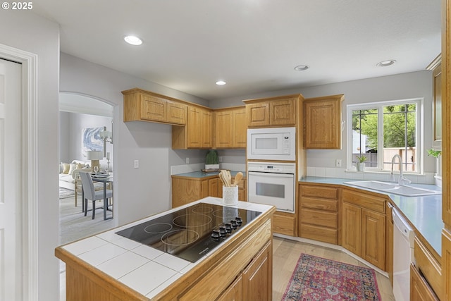 1974 SE 60th Ave, Hillsboro, OR 97123 - kitchen featuring white appliances, a sink, arched walkways, light wood finished floors, and tile countertops