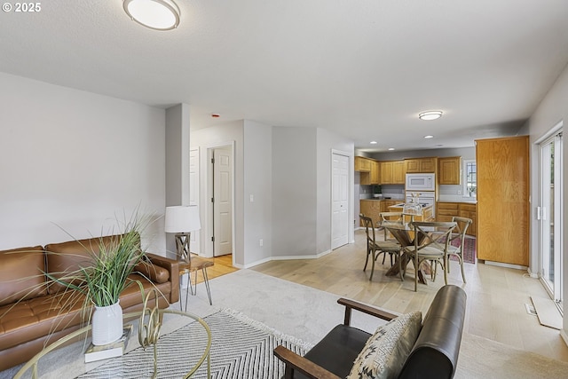 1974 SE 60th Ave, Hillsboro, OR 97123 - living room featuring light wood-style flooring, baseboards, and recessed lighting