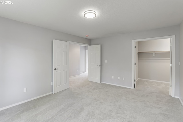 1974 SE 60th Ave, Hillsboro, OR 97123 - unfurnished bedroom with light colored carpet, baseboards, a spacious closet, a textured ceiling, and a closet