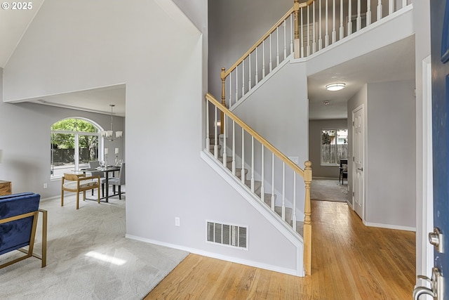 1974 SE 60th Ave, Hillsboro, OR 97123 - foyer featuring a high ceiling, stairway, baseboards, and wood finished floors