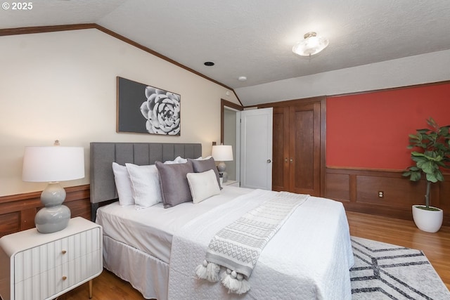 1902 N Terry St, Portland, OR 97217 - bedroom featuring vaulted ceiling, wood finished floors, wainscoting, and ornamental molding