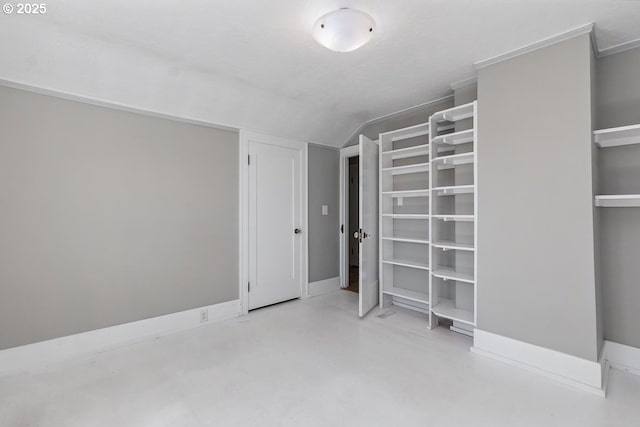 1902 N Terry St, Portland, OR 97217 - unfurnished bedroom with finished concrete floors, multiple closets, and vaulted ceiling