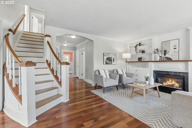1902 N Terry St, Portland, OR 97217 - living area with wood finished floors, arched walkways, crown molding, stairway, and a premium fireplace