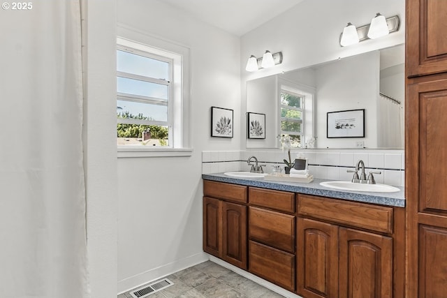 1902 N Terry St, Portland, OR 97217 - bathroom featuring double vanity and baseboards
