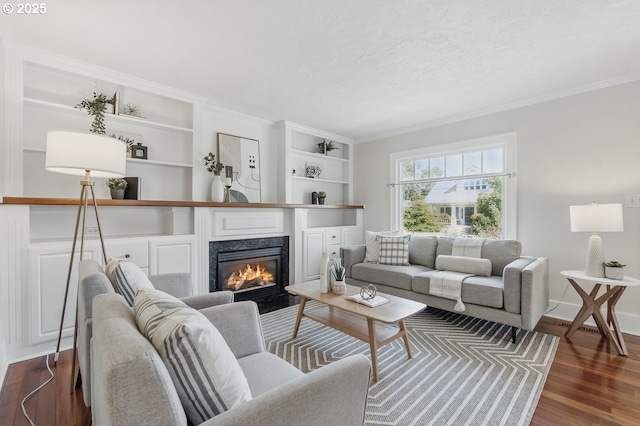 1902 N Terry St, Portland, OR 97217 - living area with ornamental molding, dark wood finished floors, built in features, a fireplace, and baseboards