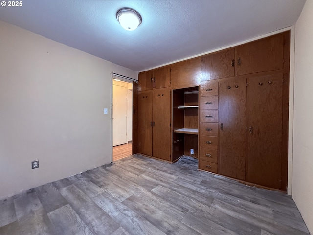 unfurnished bedroom with light wood-style floors