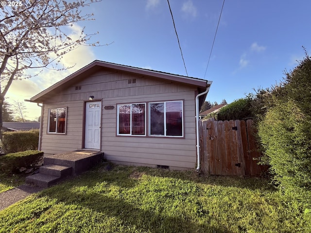 view of front facade featuring fence and crawl space
