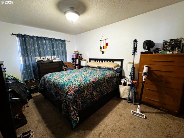 bedroom featuring a textured ceiling and carpet flooring