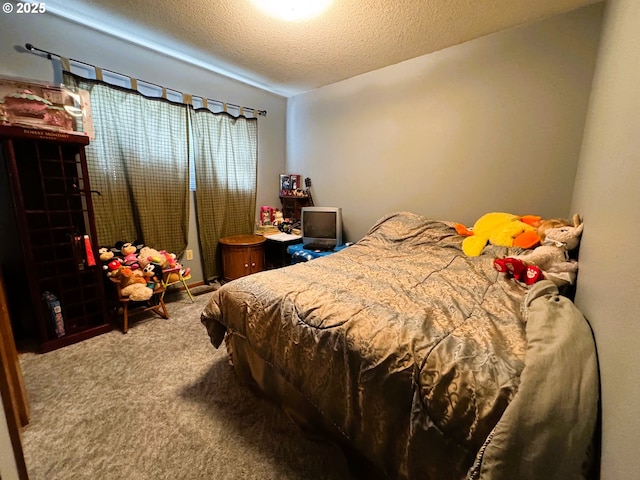 bedroom with carpet floors and a textured ceiling