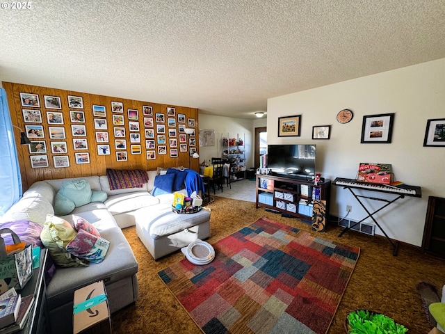 carpeted living area with a textured ceiling and wooden walls