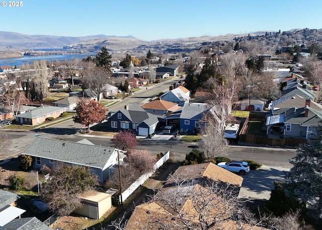 drone / aerial view with a residential view and a water and mountain view