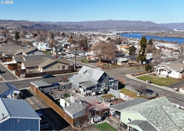 drone / aerial view with a residential view and a water and mountain view