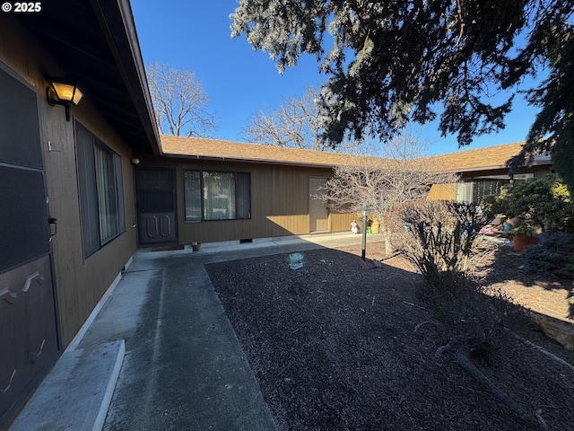 entrance to property with crawl space, a patio area, and fence