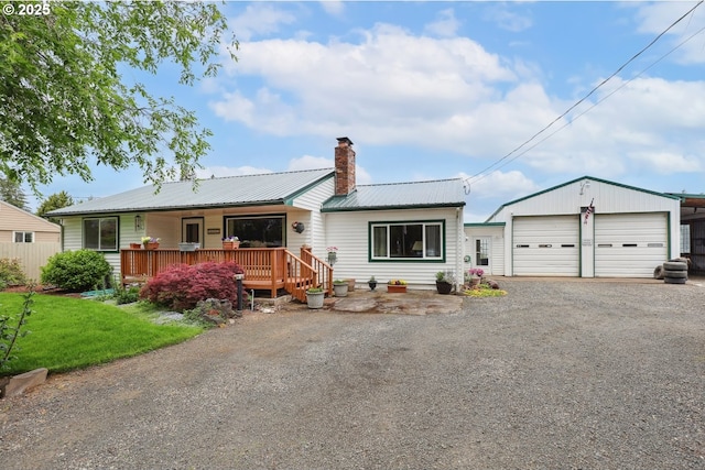 28805 Royal Ave, Eugene, OR 97402 - view of front of property with a chimney, a detached garage, metal roof, and a front lawn
