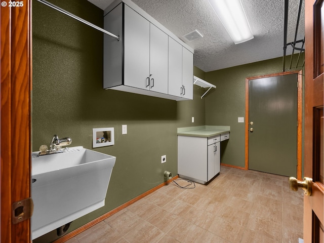 24982 E Tillicum St, Welches, OR 97067 - clothes washing area featuring cabinet space, hookup for a washing machine, a textured ceiling, baseboards, and electric dryer hookup