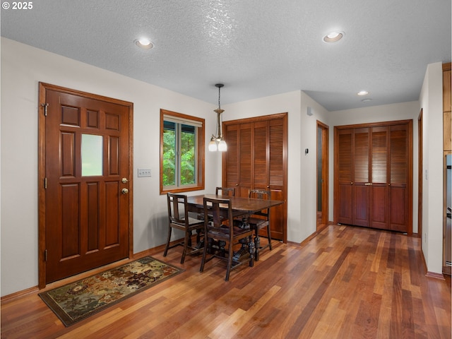 24982 E Tillicum St, Welches, OR 97067 - dining room featuring a textured ceiling, wood finished floors, baseboards, and recessed lighting