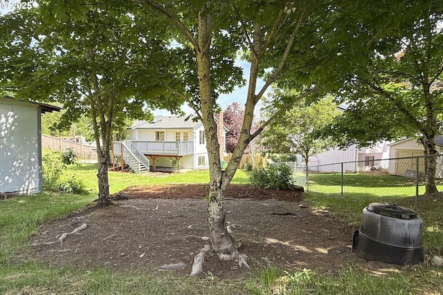 view of yard with stairs and a deck