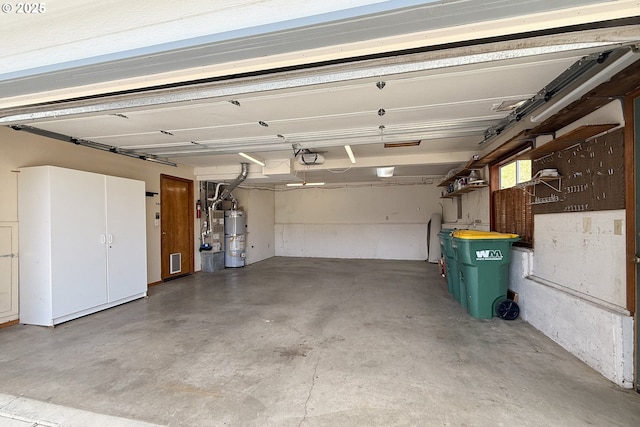 garage with a garage door opener and water heater