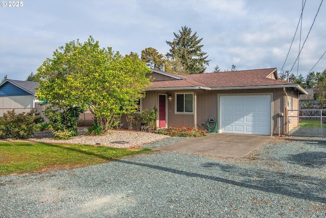 view of front of home featuring an attached garage, driveway, fence, and roof with shingles