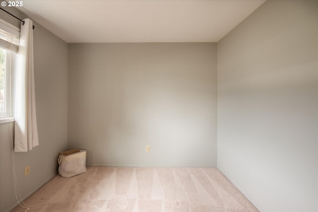 unfurnished room with light carpet