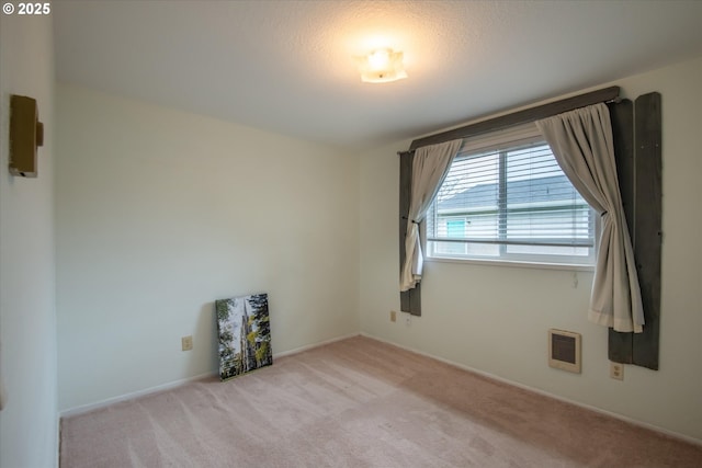 unfurnished room featuring light colored carpet and visible vents