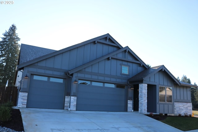 view of front of home featuring stone siding, board and batten siding, and an attached garage