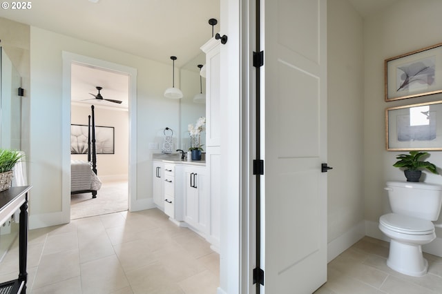 bathroom with toilet, tile patterned floors, and vanity