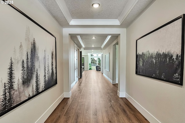 4905 NE 132nd Cir, Vancouver, WA 98686 - hallway featuring a tray ceiling, hardwood / wood-style flooring, baseboards, a textured ceiling, and ornamental molding