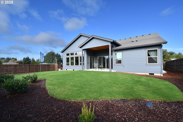 rear view of house featuring a patio area and a yard