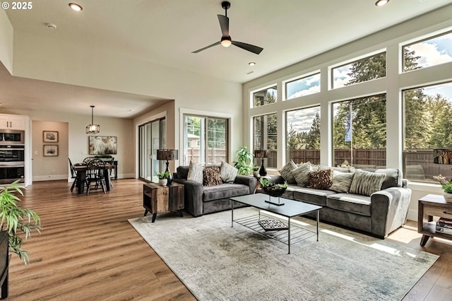 4905 NE 132nd Cir, Vancouver, WA 98686 - living room with light wood-style flooring, a ceiling fan, recessed lighting, baseboards, and a towering ceiling