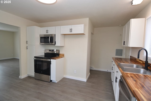 3159 Florida St, Longview, WA 98632 - kitchen featuring butcher block counters, stainless steel appliances, white cabinetry, and light wood finished floors