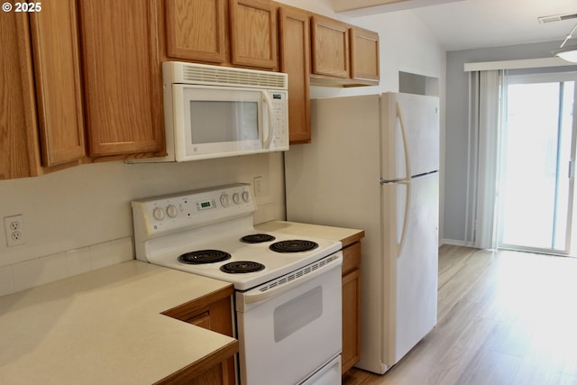 203 Robin Ct, Creswell, OR 97426 - kitchen featuring white appliances, light countertops, brown cabinets, and light wood-style flooring