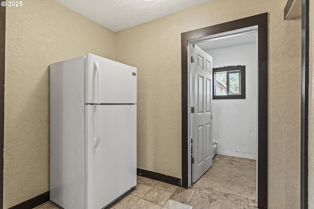530 21st Ave, Longview, WA 98632 - kitchen with freestanding refrigerator, a textured wall, and a textured ceiling