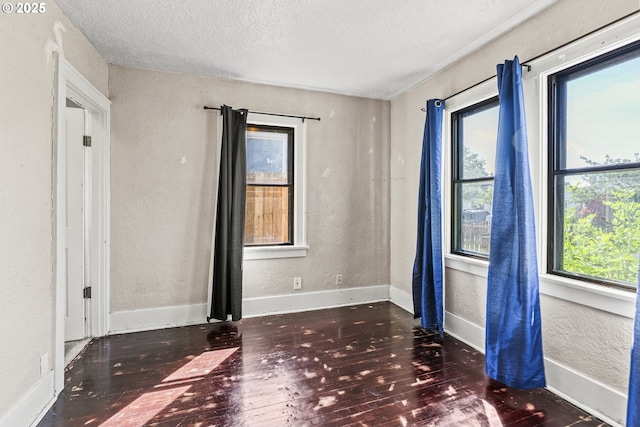 530 21st Ave, Longview, WA 98632 - unfurnished room with a textured wall, a textured ceiling, hardwood / wood-style flooring, and baseboards