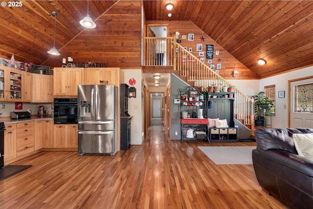 18122 Hulden Ln, Arlington, OR 97812 - kitchen featuring stainless steel fridge, light brown cabinetry, open floor plan, wooden ceiling, and high vaulted ceiling
