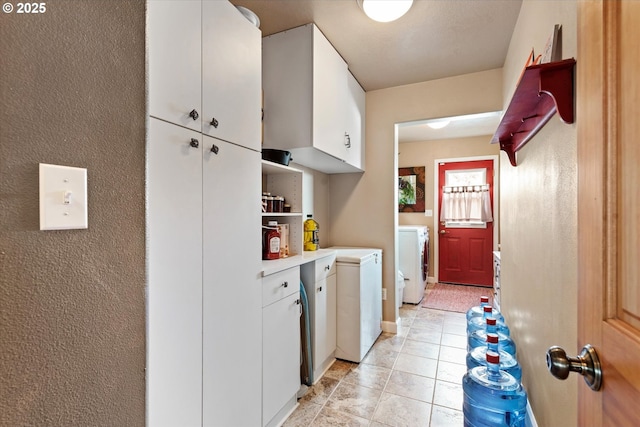 18122 Hulden Ln, Arlington, OR 97812 - kitchen with washer / dryer, light countertops, white cabinets, and light tile patterned floors