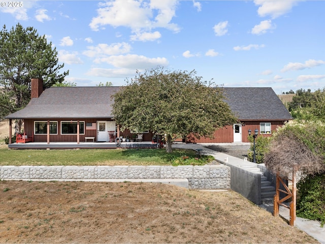 18122 Hulden Ln, Arlington, OR 97812 - view of front of property with a chimney, a front lawn, a shingled roof, and board and batten siding