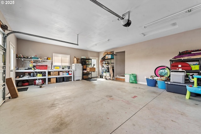 18122 Hulden Ln, Arlington, OR 97812 - garage with a garage door opener and freestanding refrigerator