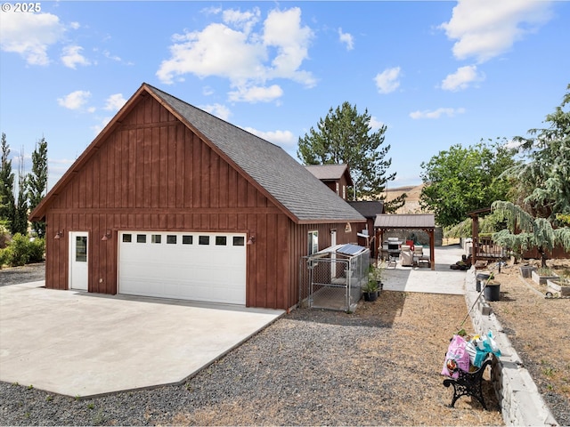 18122 Hulden Ln, Arlington, OR 97812 - view of home's exterior with roof with shingles, a garage, and an outdoor structure