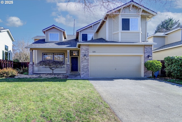 craftsman-style home with brick siding, covered porch, fence, driveway, and a front lawn